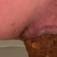 Close rear-view of Nazzy over the toilet pushing out a thick hanging turd into the water. Presented in 720P vertical HD format. About half a minute.